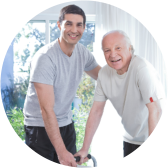 male caregiver assisting senior man with walker